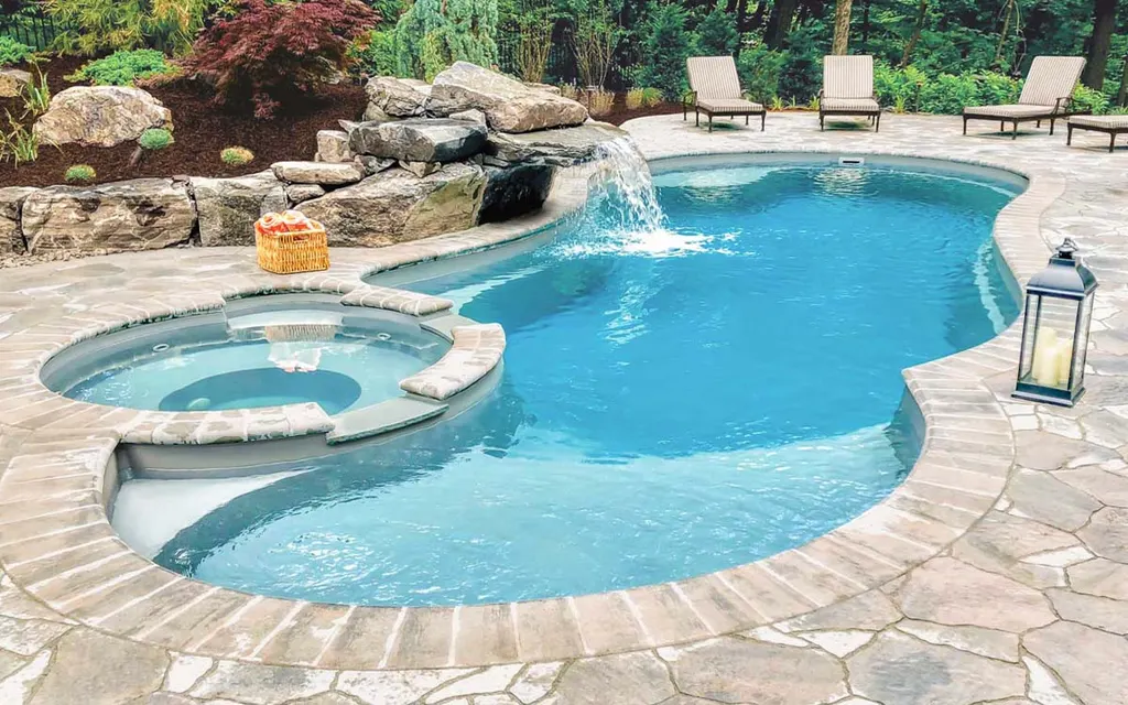 Clean residential backyard swimming pool with clear blue water